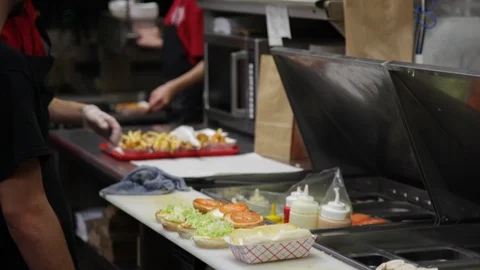 Fast food workers prepare food Stock Footage