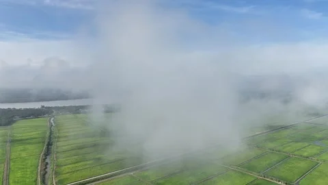 Fast Forward Drone Flight Through Clouds Toward Distant River and Bridge Stock Footage 328396318