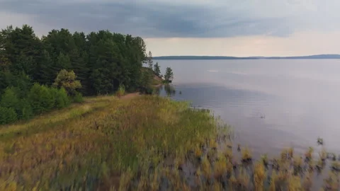 Fast forward fly over the lake's surface with slow ascend after Stock Footage 346637672