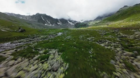 Fast forward FPV flight tracking over mountain stream and valley Video stock 345711048