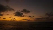 Fast Forward Motion Of Dusk Sky With Small Dark Clouds Passing Over The Sea Stock Footage
