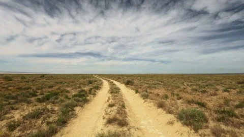 Fast forward movement along an arid dirt road Stock Footage 345840023
