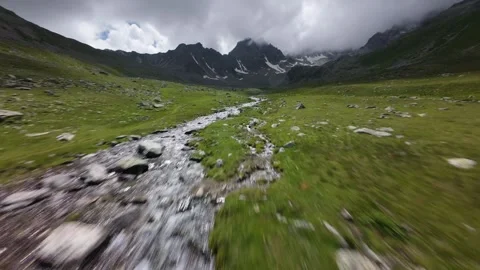 Fast forward movement along mountain stream in valley Video stock 344966983