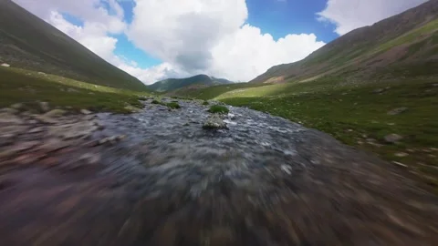 Fast forward movement along a winding river in a mountain valley Stock Footage 344419425