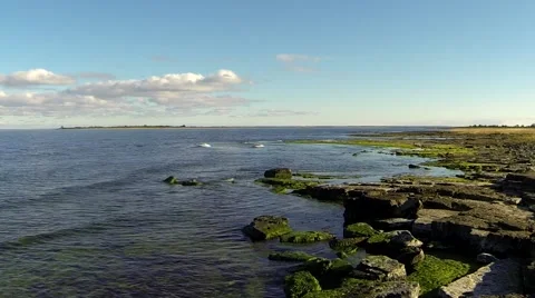 Fast forwarded waves on rocky shore Stock Footage 57853704