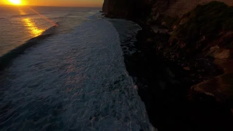 Fast FPV Drone Dive Above Karang Boma Cliff During Golden Sunset, First Person F Stock Footage 336636883