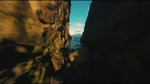 Fast FPV Drone Dive Through Narrow Rocky Passage in Lush Tropical Cliffside 스톡 동영상 319296815