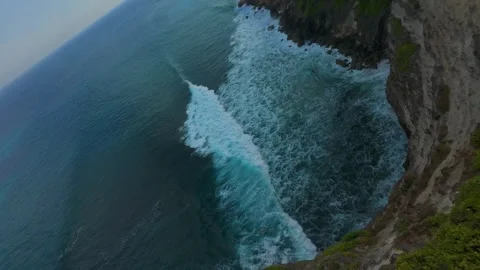 Fast FPV Drone Dive Toward Breaking Waves Below Coastal Cliffs While Independent Stock Footage 336643562