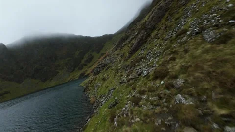 Fast fpv drone flying over welsh lake in snowdonia Stock Footage 327065735