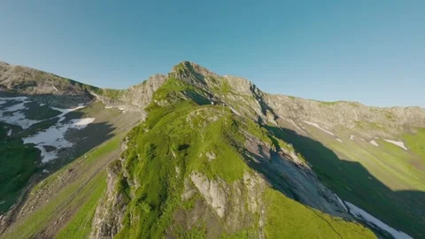Fast fpv drone pass over lush rocky alpine slope Stock Footage 336630666