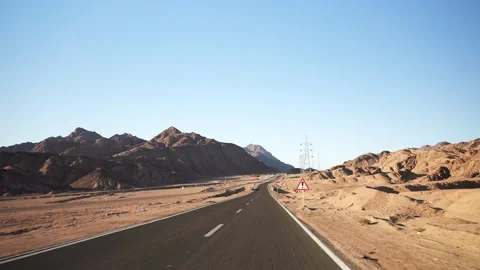 Fast fpv motion on the empty asphalt highway in the desert with road surface Stock Footage 251885495