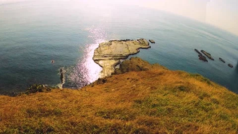Fast horizontal pane view to rock platform that shapes like little Taiwan island Stock Footage 238498850