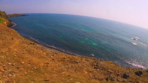 Fast horizontal super wide angle view of look out to clear shallow ocean sea hor Stock Footage 238500382