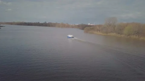 Fast hovercraft of blue and white colour sails along river Stock Footage 155286517