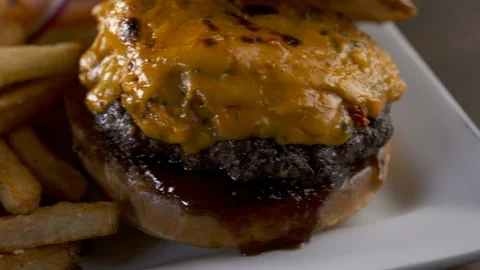 Fast left pan of cheese burger with fries Stock Footage 112575070