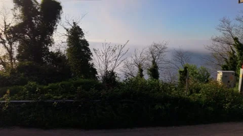 Fast Left-to-Right Motion Across a Winding Coastal Road in Slow Motion Stock-Footage 341814624
