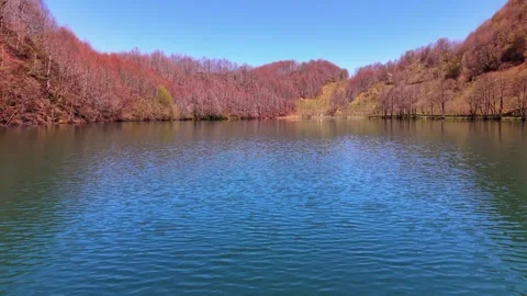 Fast Low Drone Flight Just Above Crystal Blue Lake in 4K Stock-Footage 339092671