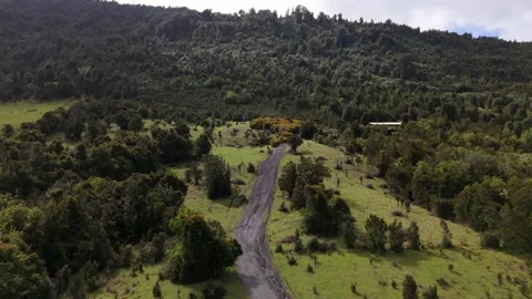Fast Low Drone Flight Over Wet Dirt Road Ascending Mountain Hill 库存影片 333773919