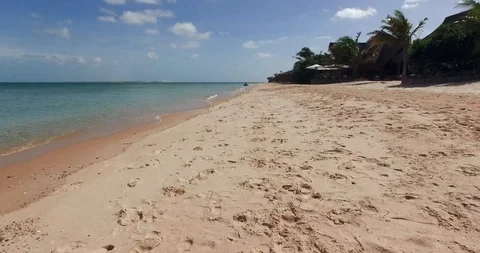 Fast low flight over the surf line of the beach on Benguerra Island. Mozambique Stock-Footage 121780505
