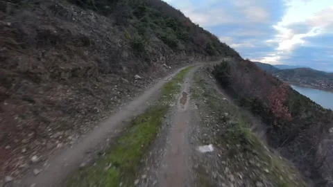 Fast Low FPV Drone Flight Over Dirt Road with Tikvesh Lake, Macedonia Stock Footage 330514281