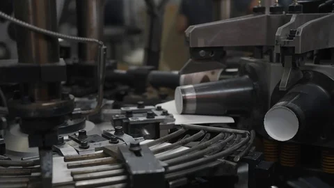 Fast manufacturing process of paper cup for hot drinks. Rotating machine parts. Stock Footage 92670597