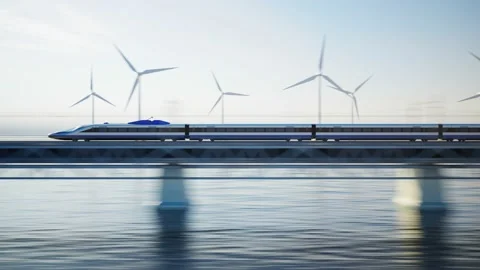 Fast modern train on bridge over water with wind turbines in the background Vidéo 234321984
