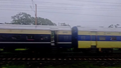 Fast motion blur of an Indian passenger train passing on adjacent tracks Stock Footage 342861287