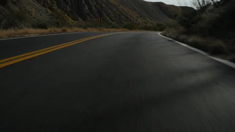Fast motion driving POV on a hilly and curvy country road Stock Footage 223566044