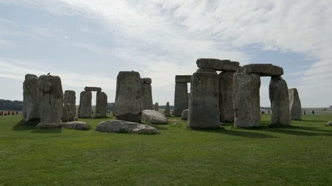 Fast Motion-Far distant visitors behind prehistoric Stonehenge Stock Footage 95649873