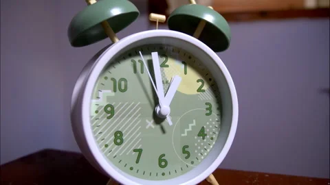 Fast-Motion Macro View of a Vintage Green-Faced Twin-Bell Clock on Wood Stock Footage 338297252