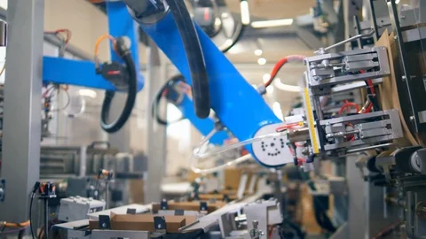 Fast motion of packaging process held by a robotic mechanism Stock Footage 115107121