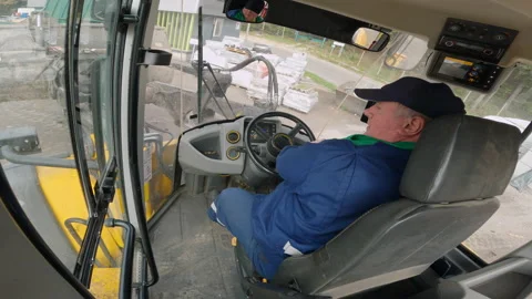 Fast motion shot of a front loader loading waste in a truck, cabin view Video stock 234203543