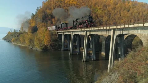 Fast motion steam train arched bridge Baikal Siberian Railway Autumn 4K drone Stock Footage 142777240
