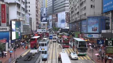 Fast motion timelapse busy street Hong Kong rainy day China jam tram people bus Stock Footage 24742764