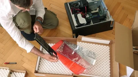 Fast motion timelapse of Man unpacking unboxing the Nvidia Quadro p4000 GPU Stock Footage 79244073