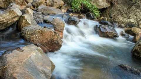 Fast motion timelapse video of large rocks in a river Stock Footage 61787829