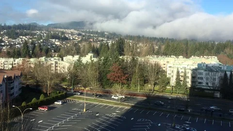 Fast motion of traffic flow and low rise apartment on cold sunny day Stock Footage 83959709
