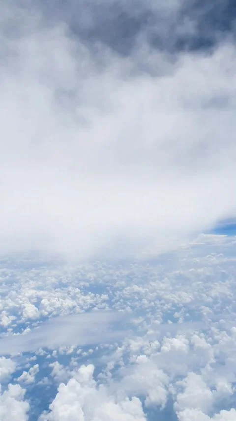 Fast motion vertical aerial view from airplane window flying above soft white cl Stock Footage 331888171