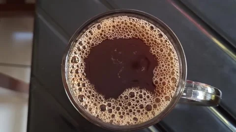 Fast motion video of bubbles in a coffee drink bursting Stock Footage 265203085