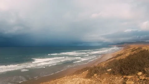 Fast motion waves in Atlantic ocean coast in Morocco with dark clouds coming Stock Footage 234110187