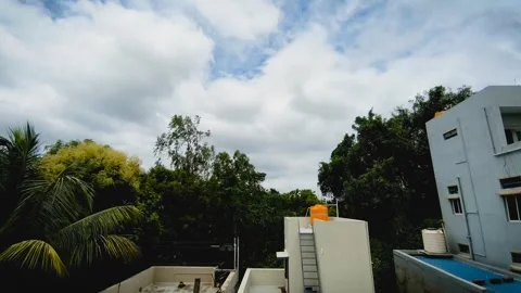 Fast Motion White Clouds Flowing Through Bright Blue Sky Timelapse Video stock 337815772
