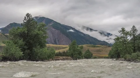 Fast mountain river and clouds on the mountain. Stock Footage 77166033