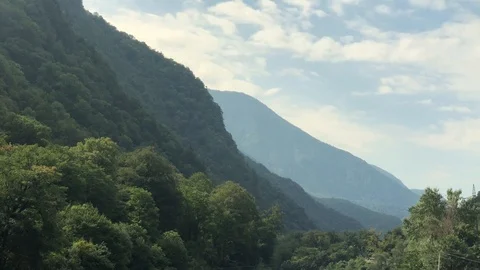 Fast mountain river flowing among mountains overgrown with old trees Stock Footage 127020931