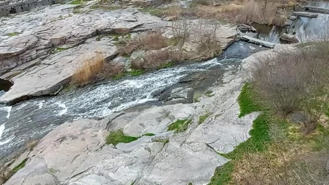 Fast mountain river flowing through granite rocks in spring forest. Stock Footage 331930962