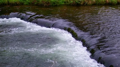 A fast mountain river flows among the rocks Stock Footage 299027602