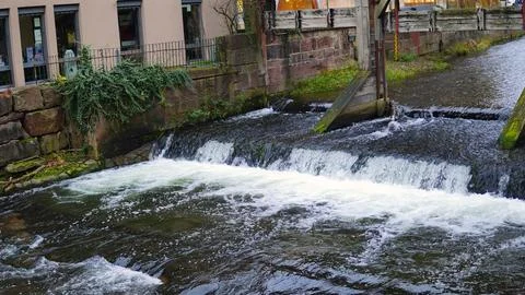 A fast mountain river flows among the rocks Stock Photos