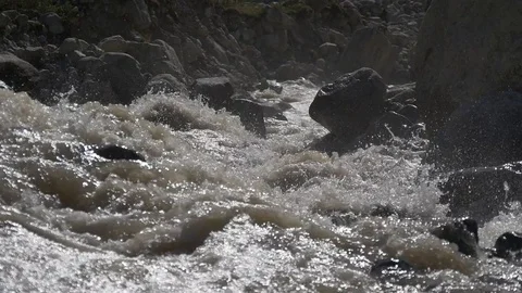 Fast mountain river splashing at huge stones Stock Footage 77248161