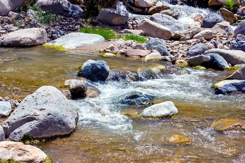 Fast mountain river stream water flowing through the rocks close up Stock Photos