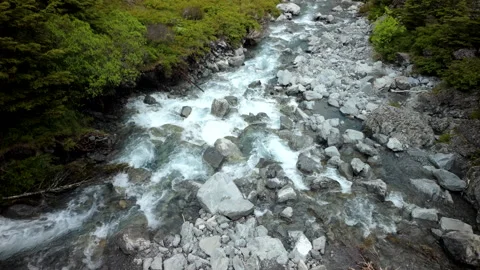 Fast mountain stream rushing over rocks in narrow riverbed Stock Footage 326501493