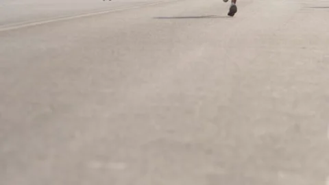 Fast movement of the athlete's legs while running on the asphalt. Video stock 139483768